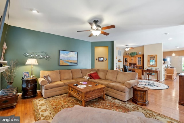 living room with ceiling fan and light wood-type flooring