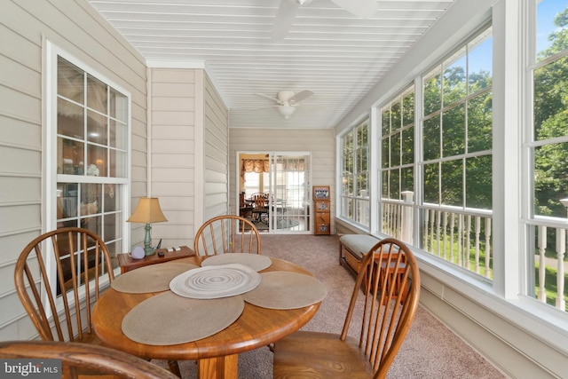 sunroom / solarium featuring ceiling fan