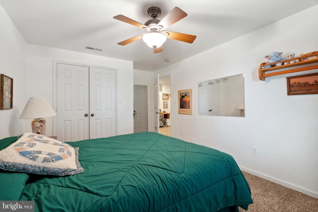 carpeted bedroom with a closet and ceiling fan