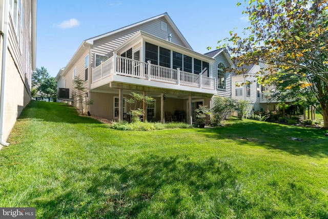 rear view of property with a yard