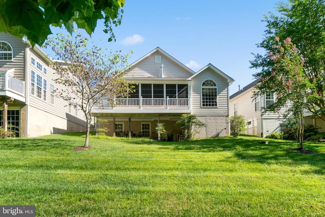 rear view of house featuring a lawn