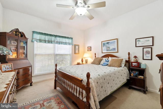 bedroom featuring ceiling fan and light colored carpet