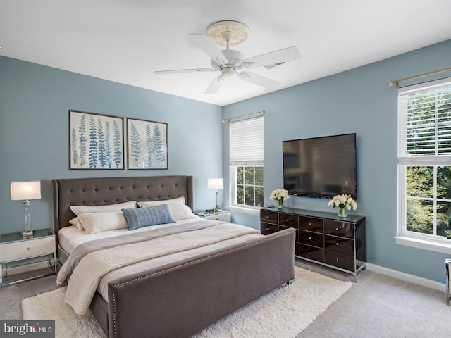 bedroom featuring ceiling fan and light carpet