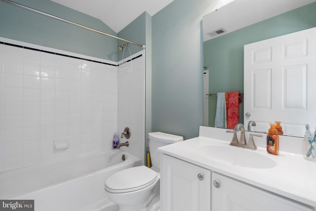 full bathroom featuring toilet, tiled shower / bath, and vanity