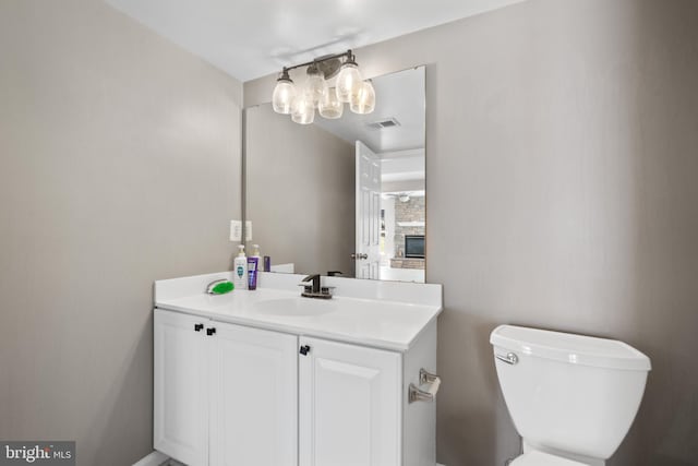 bathroom with toilet and vanity