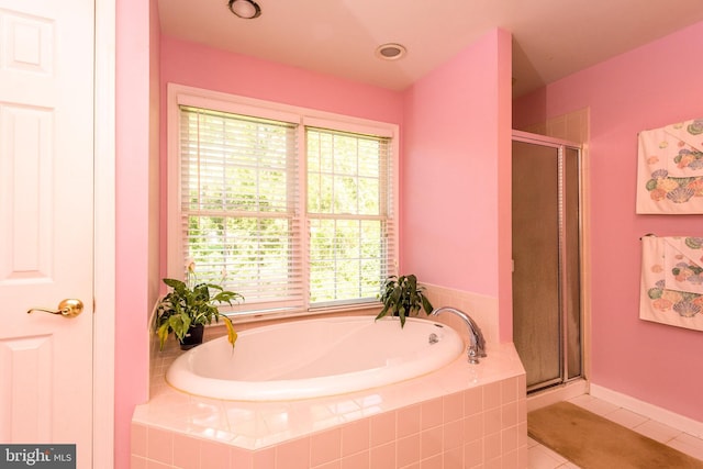 full bathroom featuring a stall shower, a garden tub, and tile patterned floors