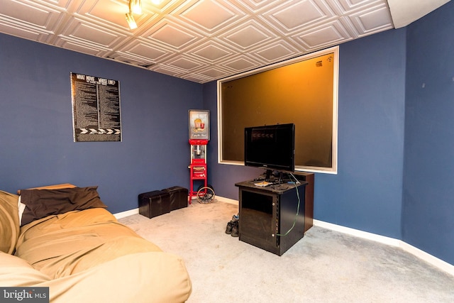 living room featuring carpet floors, an ornate ceiling, and baseboards