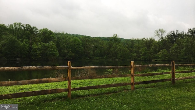 view of gate featuring a water view and a yard