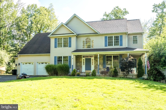 view of front of house featuring aphalt driveway, covered porch, a front yard, a garage, and stone siding