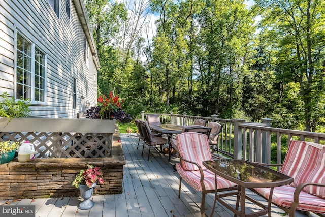 wooden deck featuring outdoor dining space