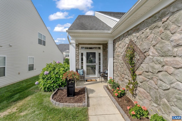 doorway to property featuring a yard