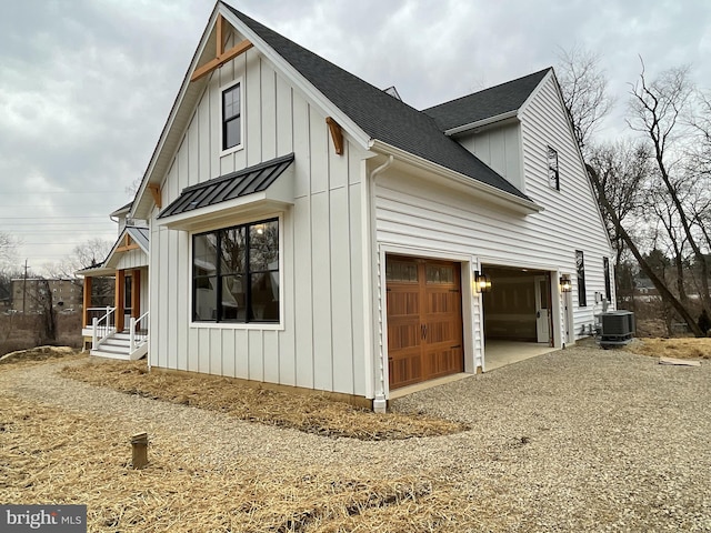 view of property exterior with cooling unit and a garage