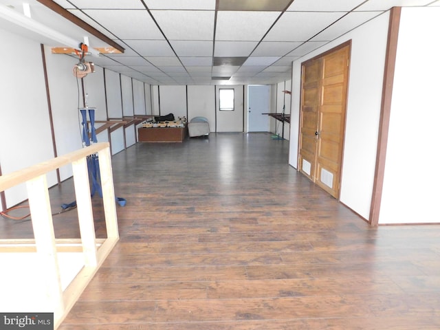 hallway with a drop ceiling and hardwood / wood-style flooring