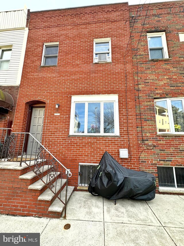 rear view of property featuring central AC