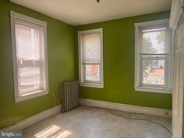 empty room with plenty of natural light and radiator