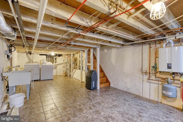 basement with light tile patterned floors, independent washer and dryer, and water heater