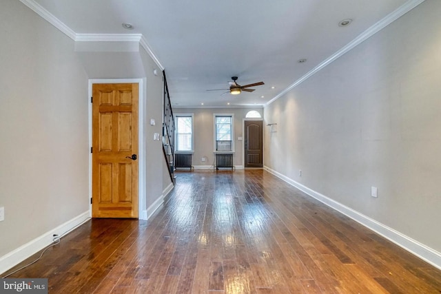 unfurnished living room featuring radiator heating unit, ceiling fan, hardwood / wood-style floors, and crown molding