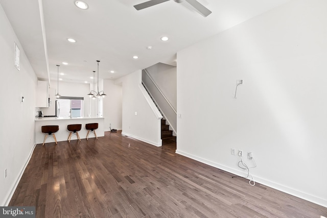 unfurnished living room featuring hardwood / wood-style floors and ceiling fan