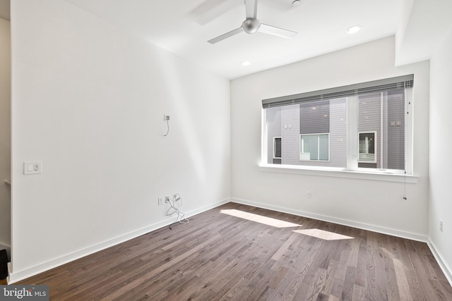 unfurnished room featuring ceiling fan and dark hardwood / wood-style floors