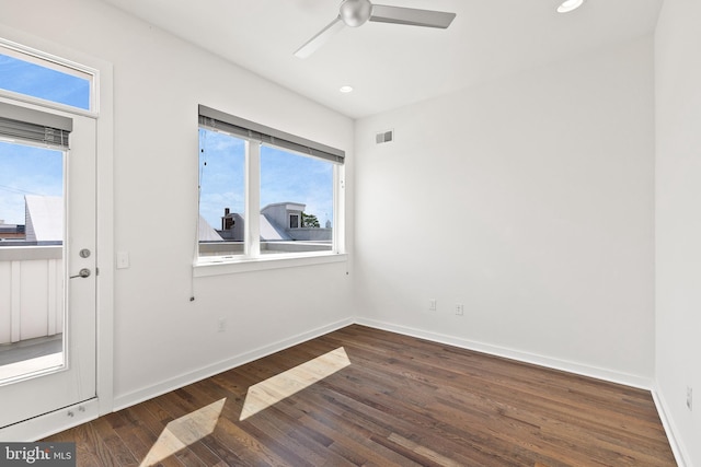 spare room featuring ceiling fan and dark hardwood / wood-style flooring