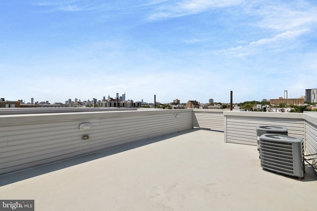 view of patio featuring central air condition unit and a balcony