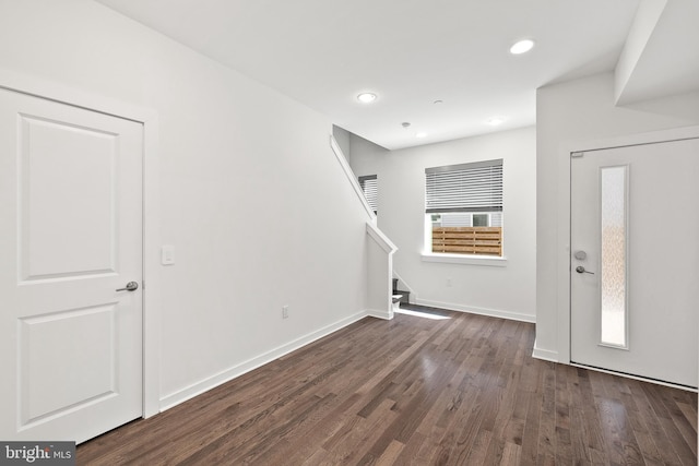 foyer with dark wood-style flooring, stairway, recessed lighting, and baseboards