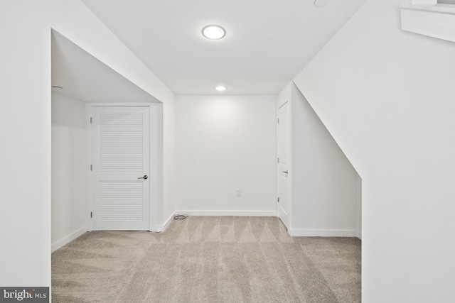 bonus room featuring light carpet and lofted ceiling