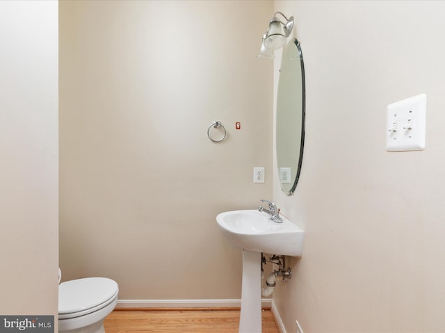 bathroom featuring toilet and hardwood / wood-style flooring