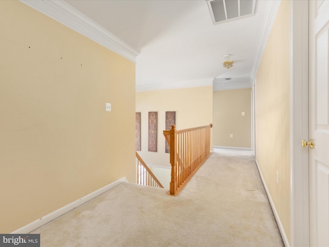 hallway with ornamental molding and light colored carpet