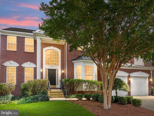 view of front of house with a lawn and a garage