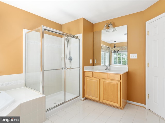 bathroom featuring tile patterned floors, a chandelier, vanity, and separate shower and tub