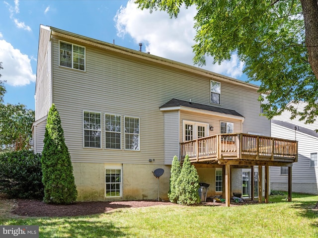 rear view of property with a lawn and a wooden deck