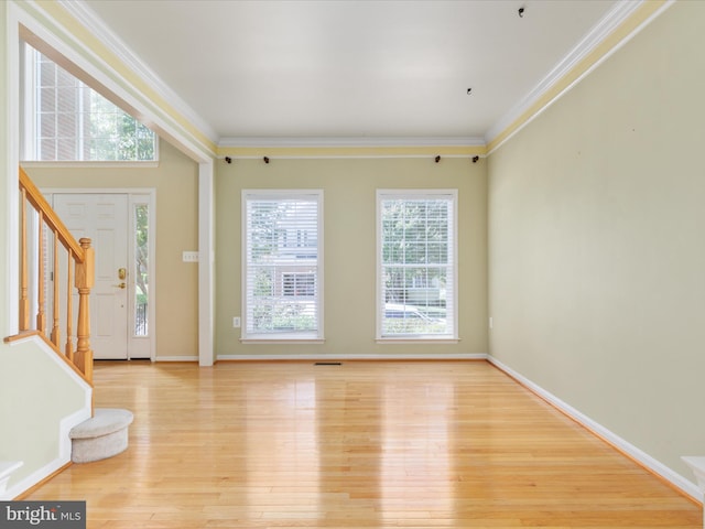 entrance foyer featuring light hardwood / wood-style flooring and crown molding