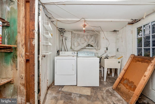 washroom with washer and clothes dryer and sink