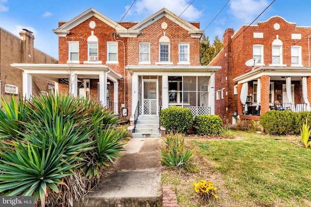 view of front of property featuring covered porch and a front yard