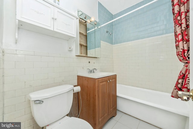 full bathroom with tile walls, vanity, toilet, and shower / tub combo with curtain