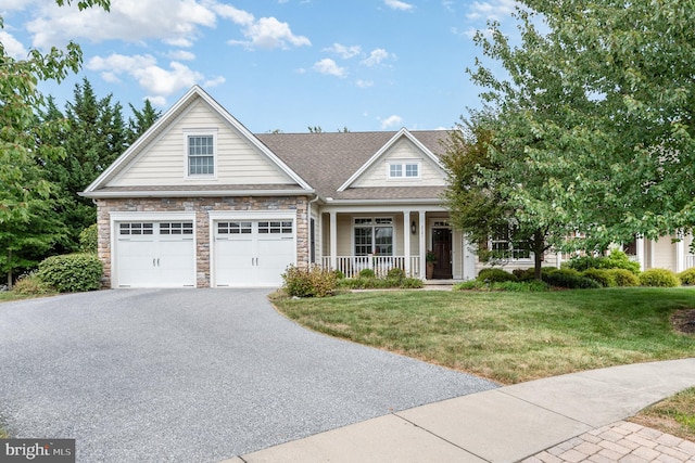 view of front facade featuring a front lawn, a porch, and a garage