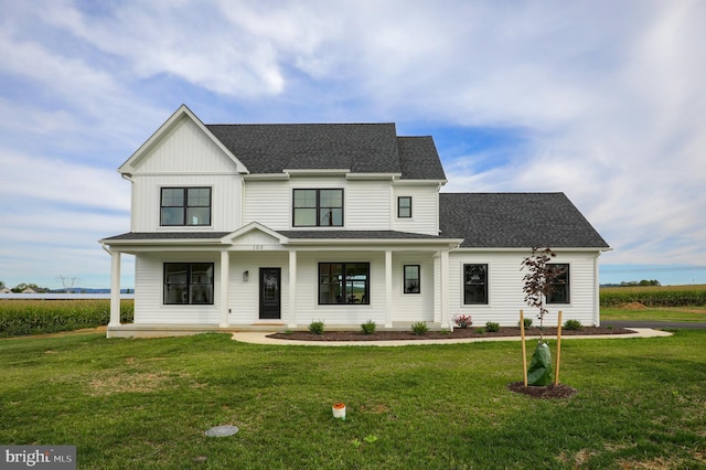 modern inspired farmhouse with covered porch and a front yard