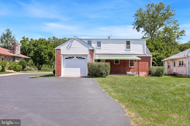 view of front of home featuring a front yard and a garage