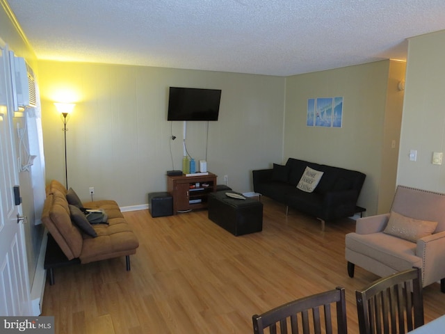 living room with a textured ceiling and hardwood / wood-style floors