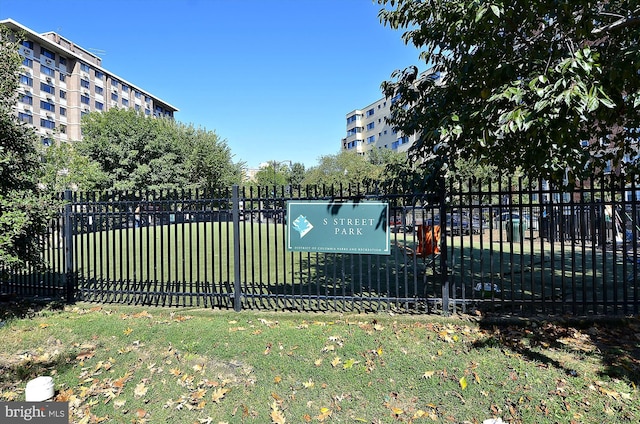 view of home's community with a yard and fence