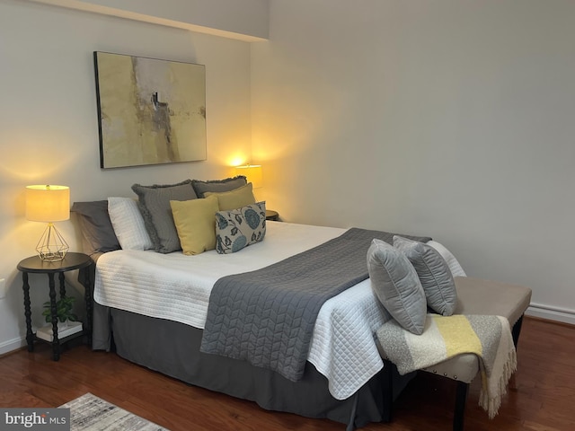 bedroom featuring baseboards and wood finished floors