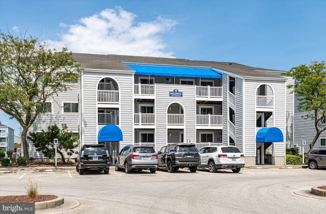 view of building exterior featuring uncovered parking