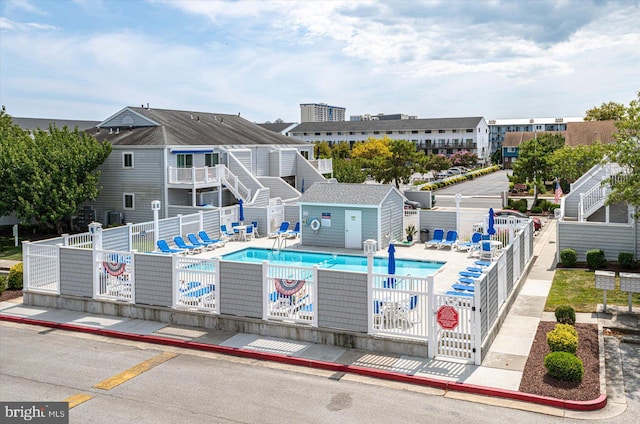 pool with fence and a patio