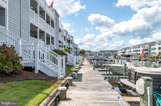 dock area featuring a water view, boat lift, and stairs