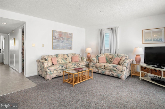 living area featuring a textured ceiling, carpet floors, and baseboards