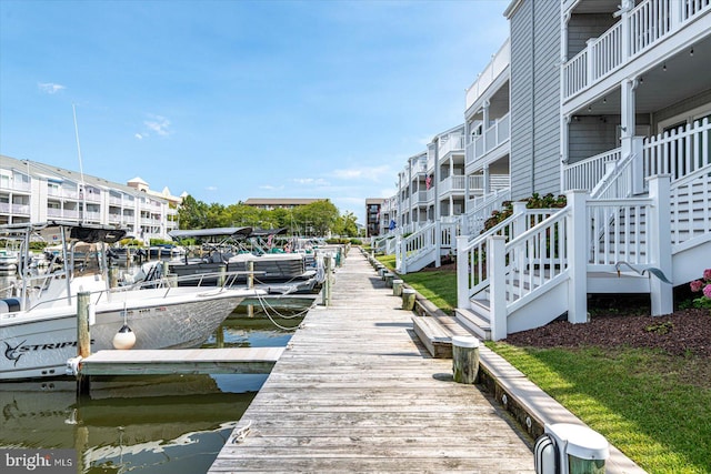 view of dock featuring a balcony and a water view