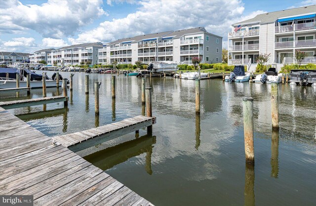 dock area with a balcony and a water view