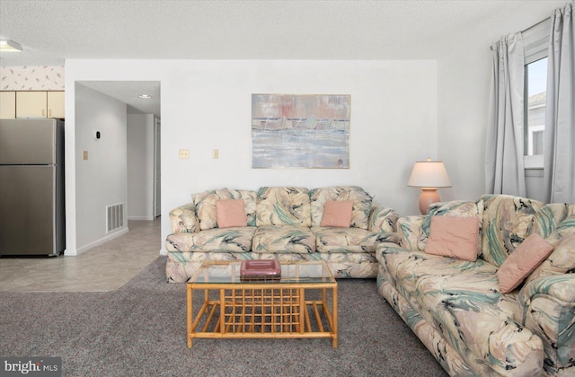 carpeted living room with a textured ceiling, visible vents, and baseboards