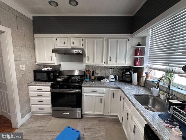 kitchen with white cabinetry, stainless steel stove, and light tile patterned floors